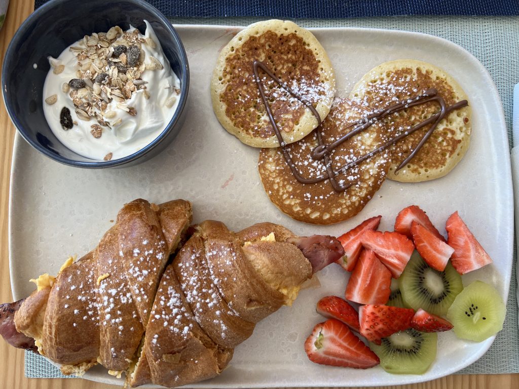 Pancake fruit yogurt and bacon and egg croissant brunch tray from Almalusa — Armação de Pêra Food Guide