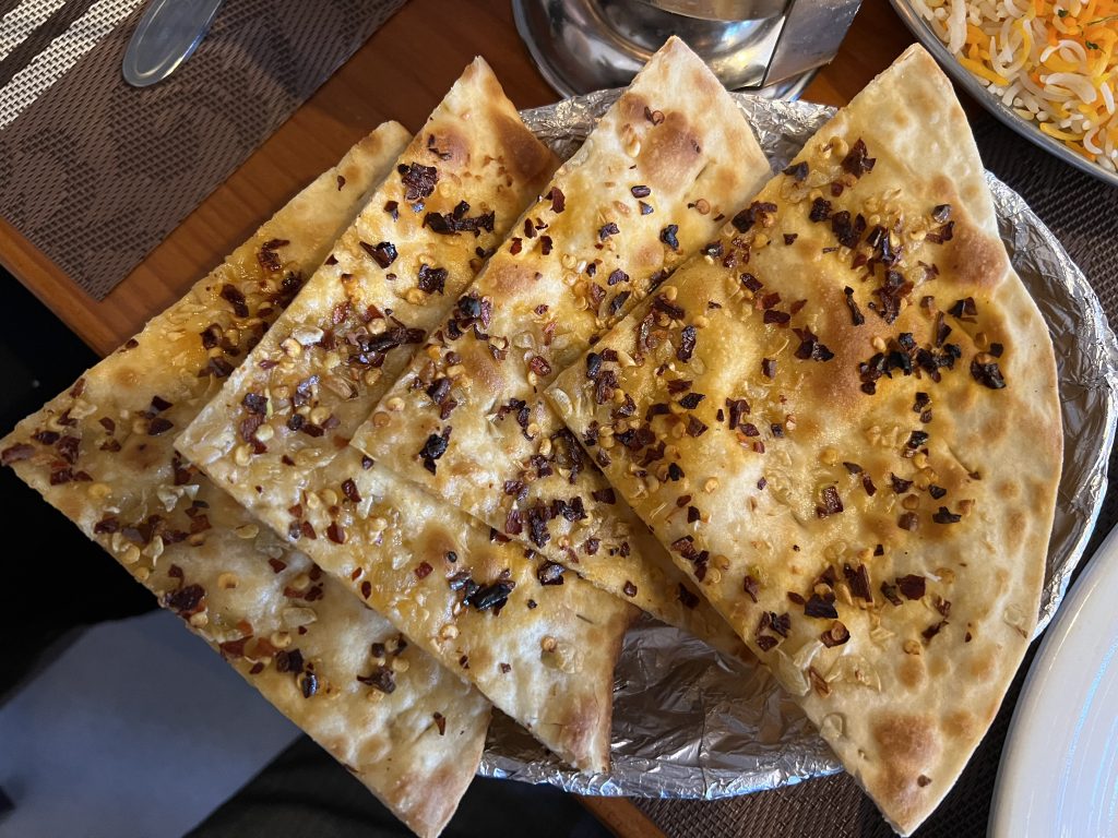 Golden naan topped with garlic and chili