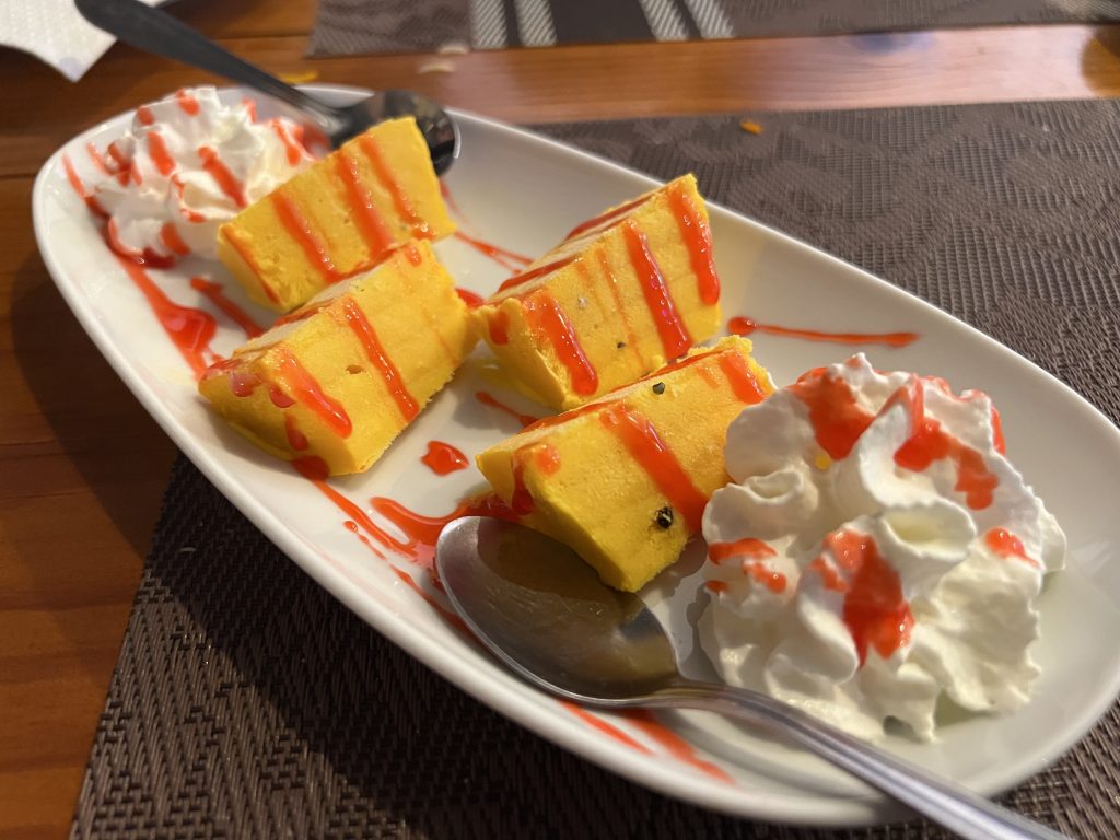 Colorful mango dessert with whipped cream