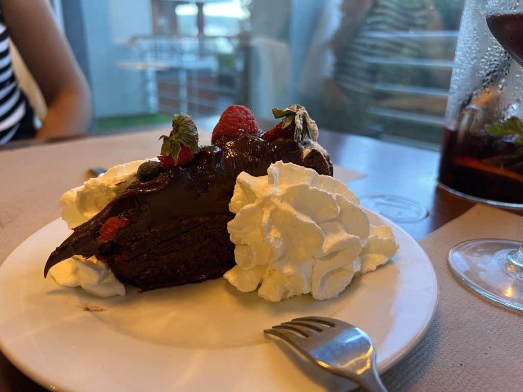 Fudgy chocolate brownie cake with raspberries and whipped cream at Bandalho Meat & Wine Carnaxide — Lisbon Restaurant Review — Portugal Food Blog