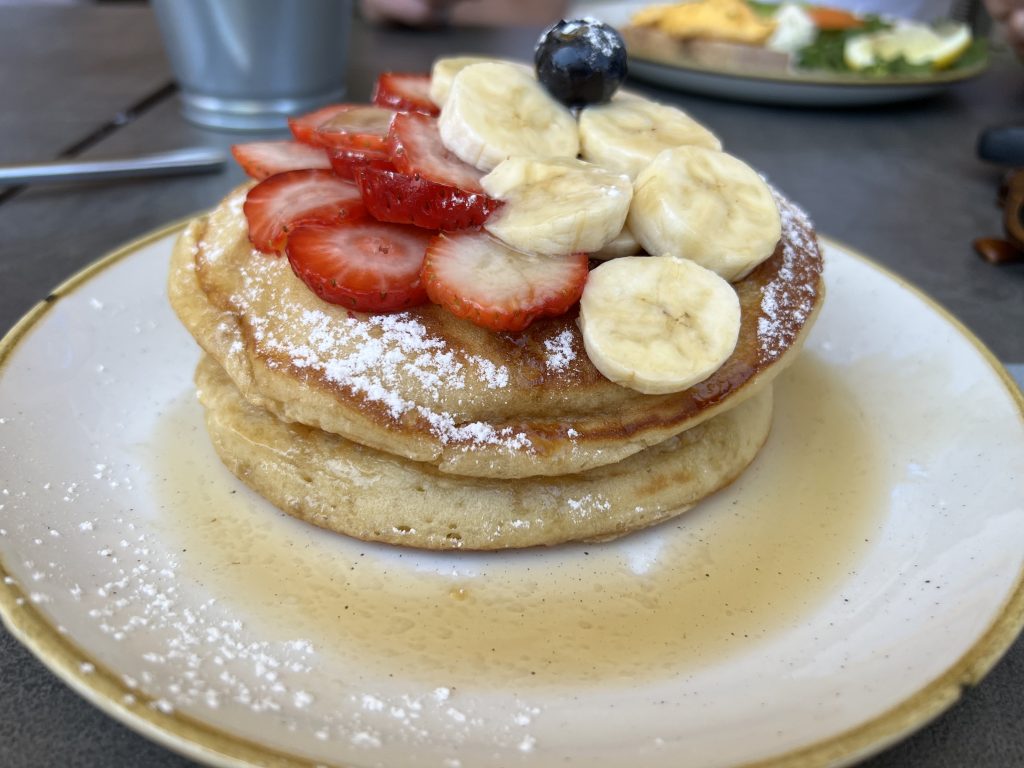Pancake Stack topped with fresh fruits at Noa Cafe Bistro in Portugal