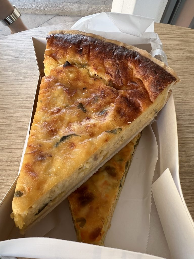2 slices of quiche in a takeout box at Pão d'Avó Maria