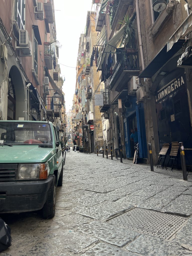 An old green car and a laundromat on a street in Naples — One Day in Naples Cruise Port 