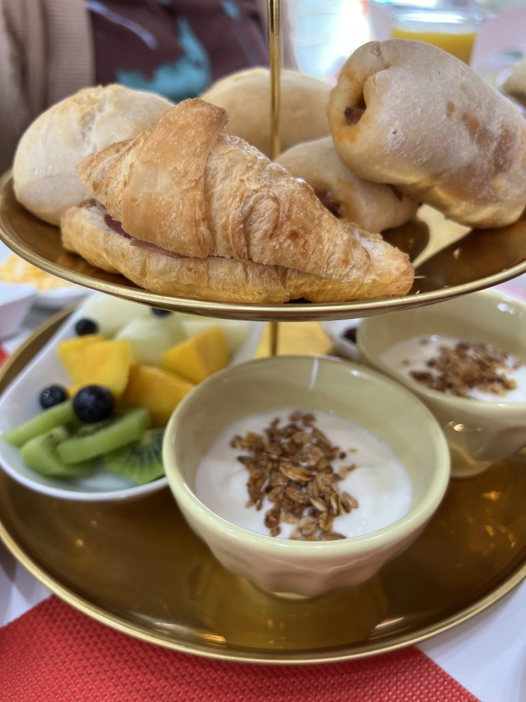 A multi tiered stand featuring croissant with ham, pao com chouriço, yogurt with granola and fresh cut tropical fruits at MB Cakes Brunch & Coffee Photos & Review 