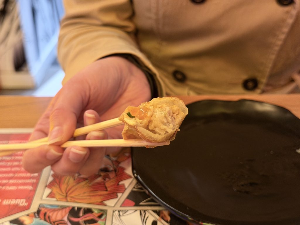 Inside Fried Gyoza held with chopsticks at Shifu Ramen Expo — Lisbon Food Blog Restaurant Reviews