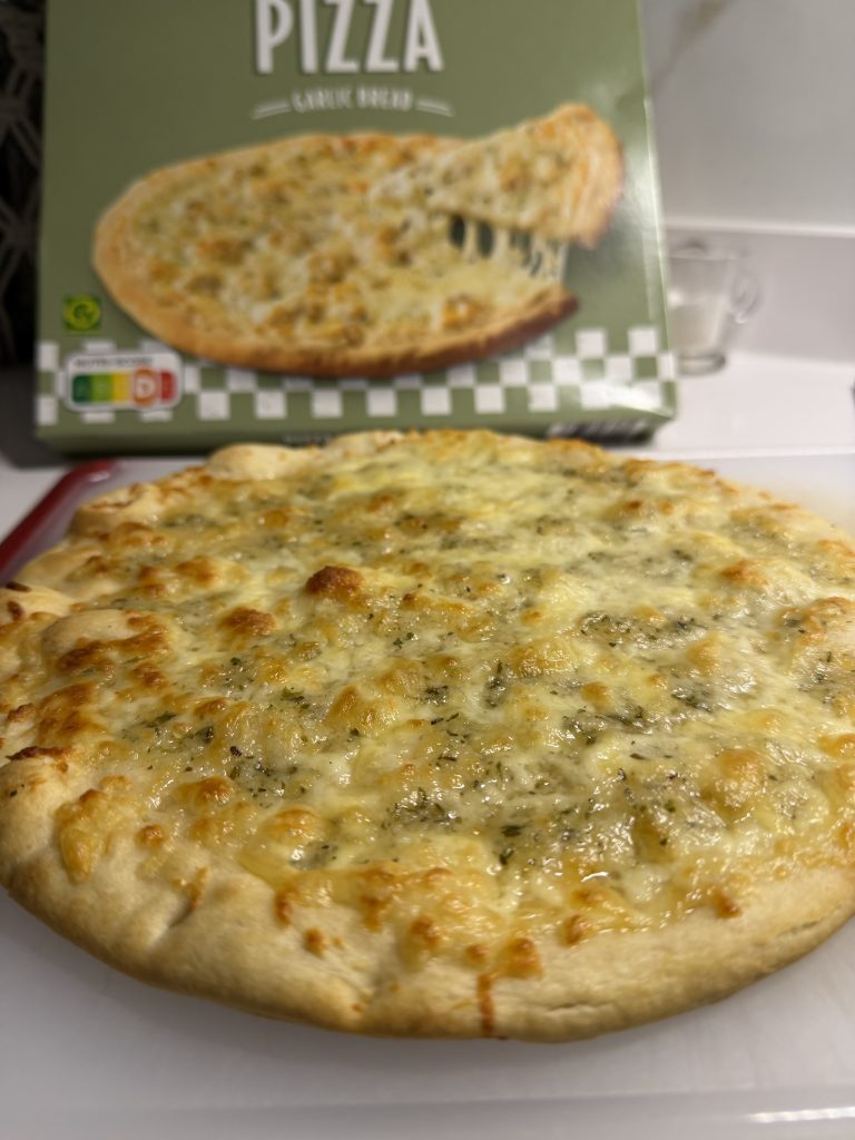 Close up of golden cheese bread — Trader Joe's Garlic Bread Pizza