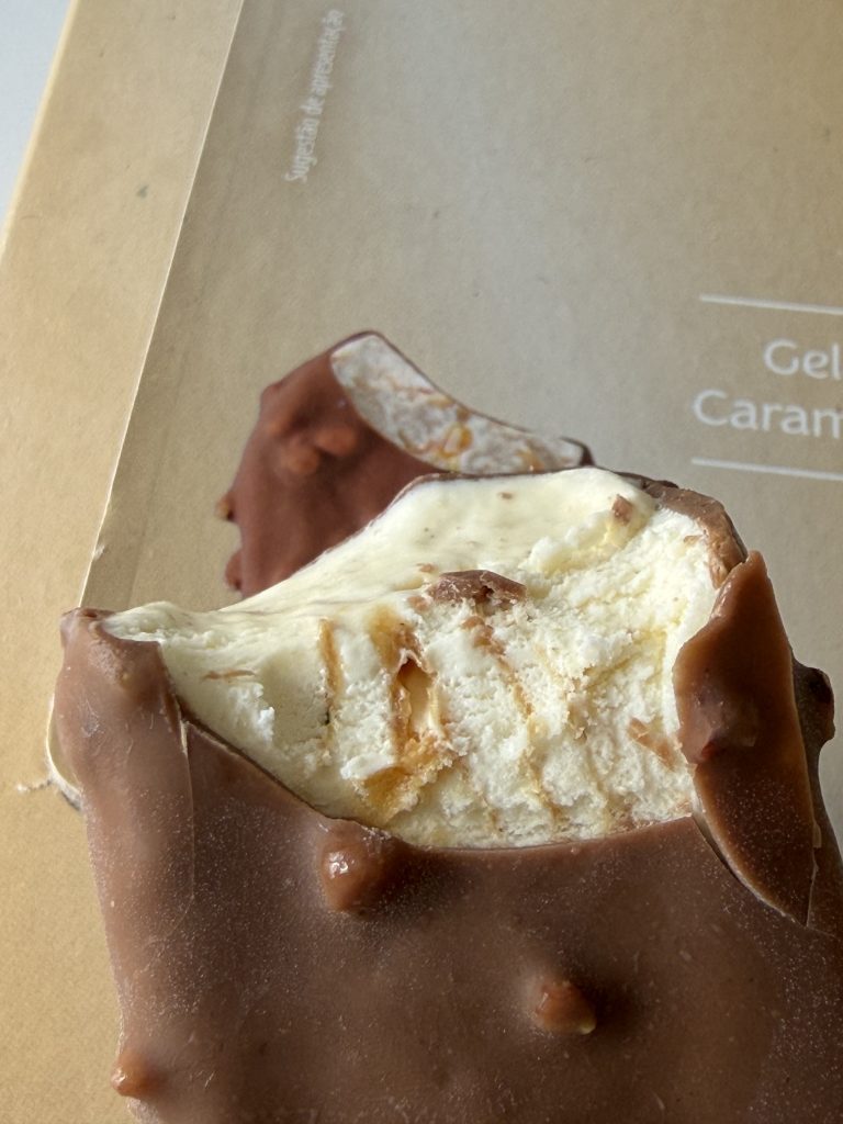 Aldi Mucci Mini Gelados vanilla salted caramel and pecan ice cream photo showing caramel ribbons in second bite