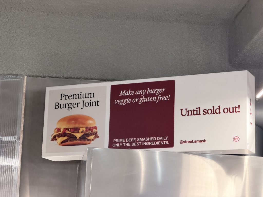 Smash Burger Signage reads "Premium Burger Joint" "Make any burger veggie or gluten free" and "Prime beef, smashed daily. Only the best ingredients"| Street Smash Burger Lisbon Review Alvalade Photos| Best Smash Burger in Lisbon?