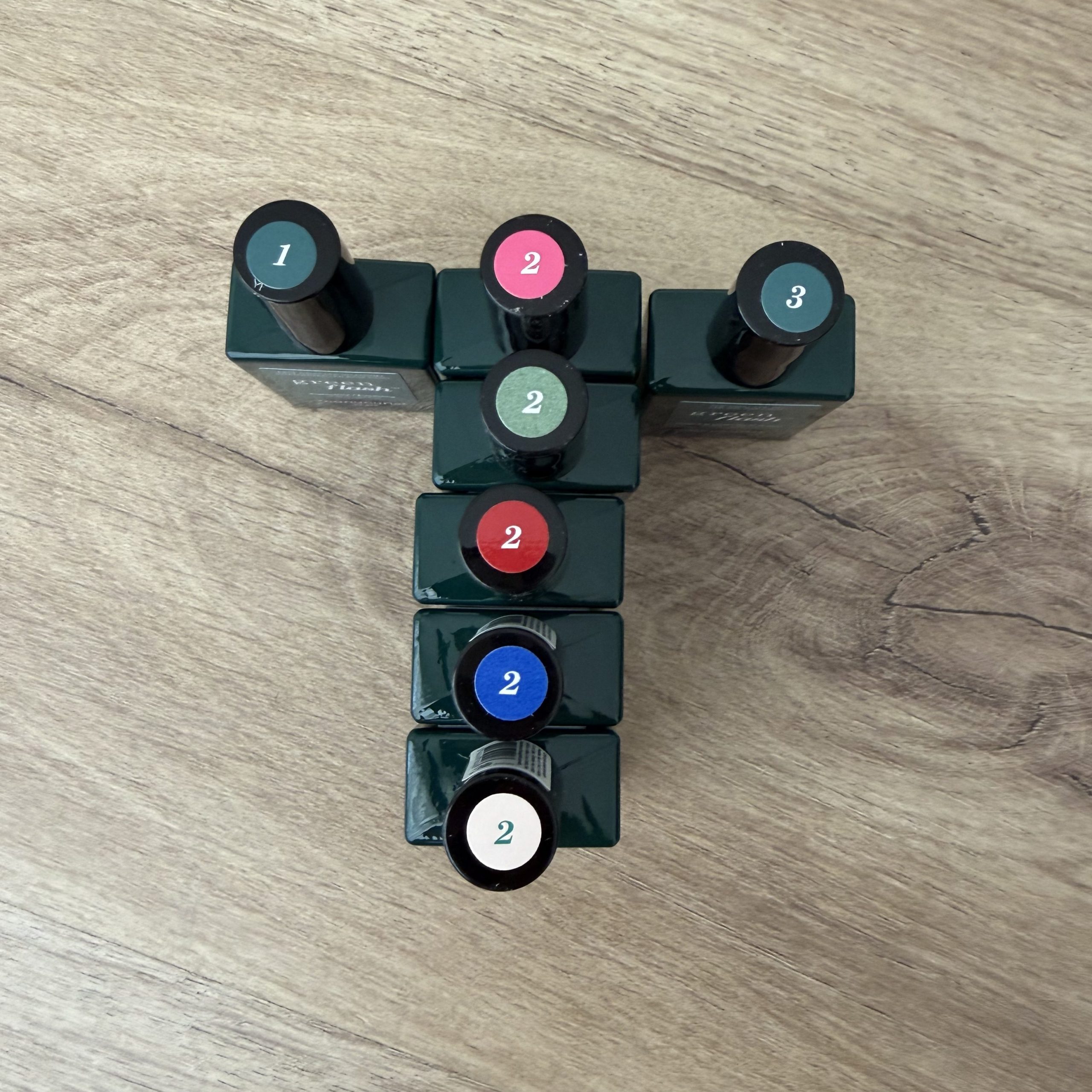 Manucurist Green Flash Starter Kit Unboxing & Review — Green Flash LED Gel Polish Bottles arranged by type to see stickers on lids, top down view