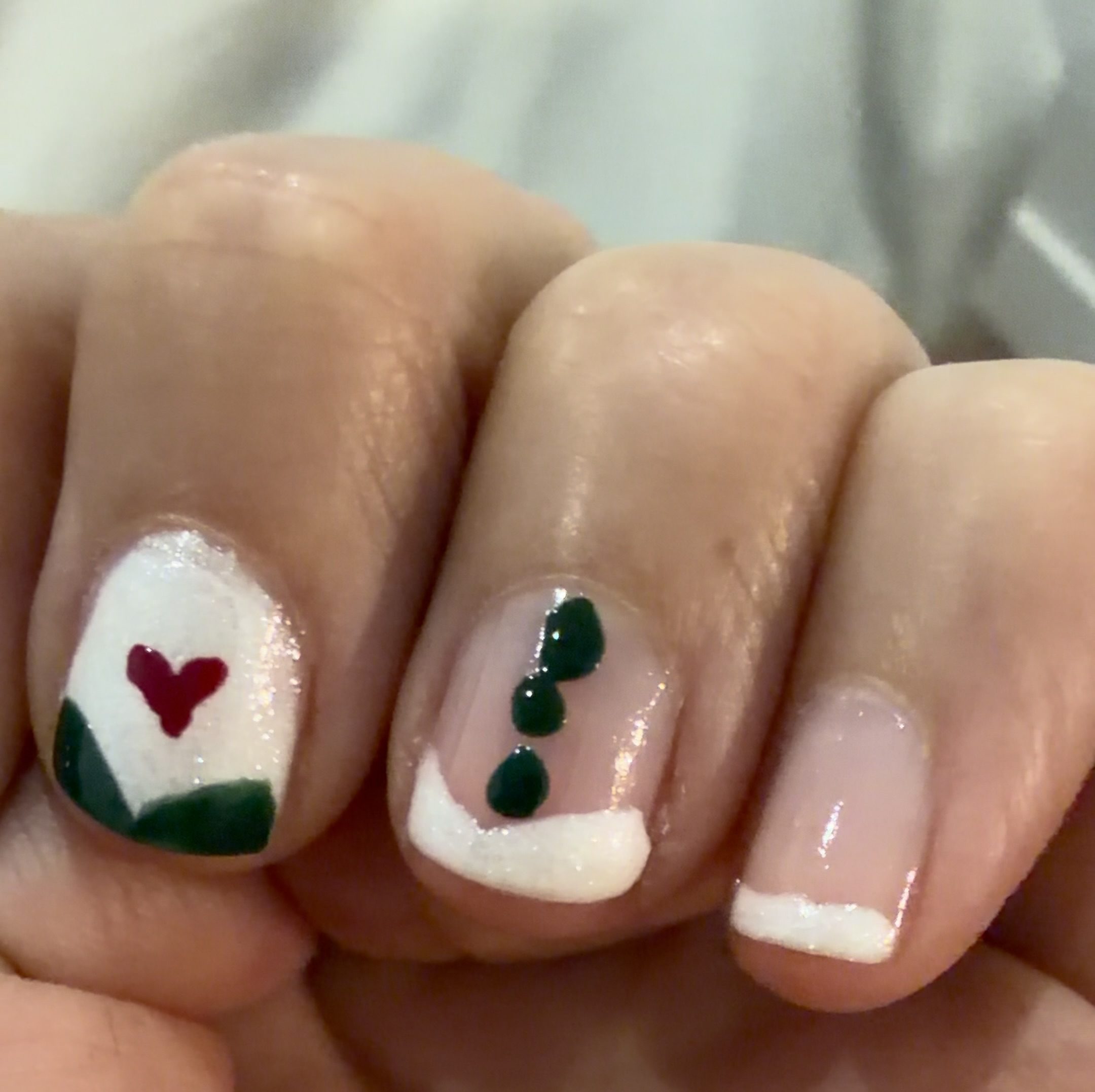 Sparkly White Angled French Tip (Bliss) with Pine Green Nail Polish Dots (Emerald) from Manucurist's Winter 2026/2027 Collection A World of Wonders