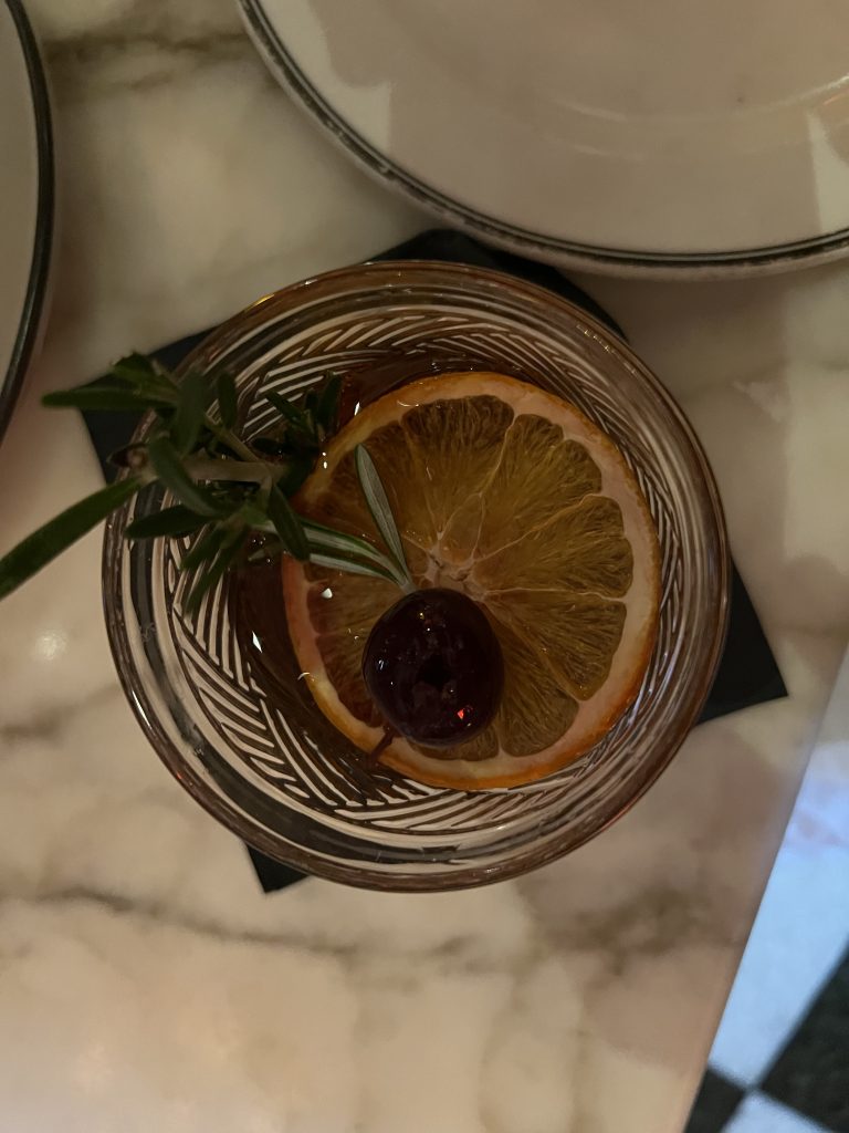 Marabu Miami Review — Cuban Old Fashioned Cocktail garnished with orange slice, rosemary sprig, and luxardo cherry | Miami Happy Hour Cuban Restaurant
