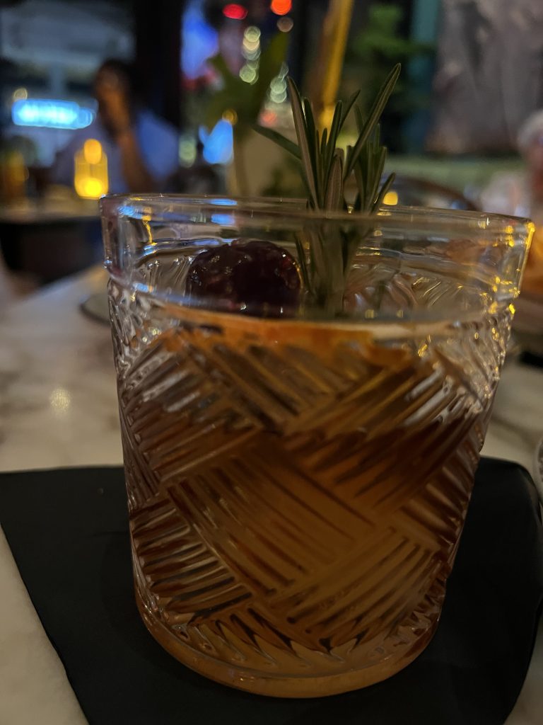 Marabu Miami Review — Cuban Old Fashioned Cocktail garnished with orange slice, rosemary sprig, and luxardo cherry | Miami Happy Hour Cuban Restaurant