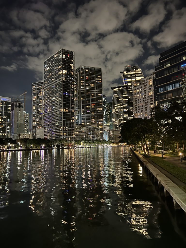 Visit Miami — Night clouds and reflections of high rise buildings twinkle on the waterfront
